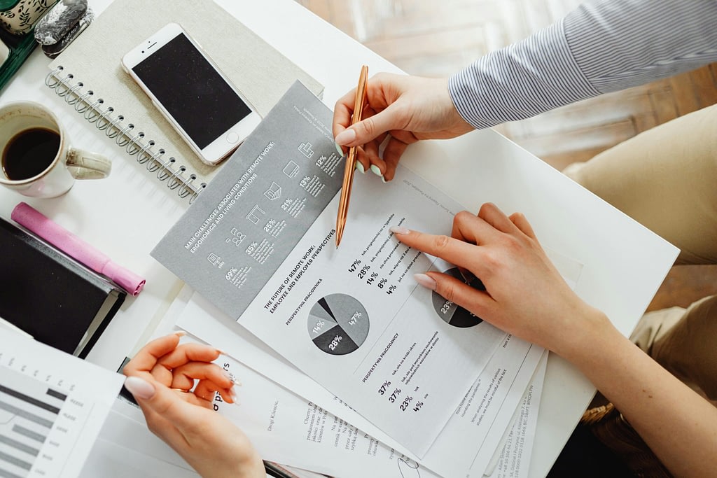 Business owner working with a finance professional to review financial reports