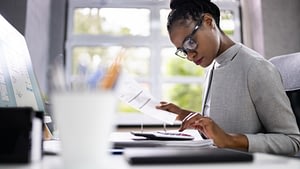 business owner reviewing financial data with accounting advisor in office