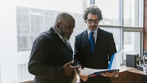 Business owner reviewing financial reports with an outsourced CFO in South Africa