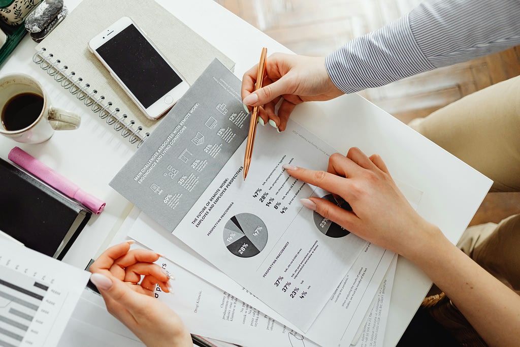 Business owner working with a finance professional to review financial reports